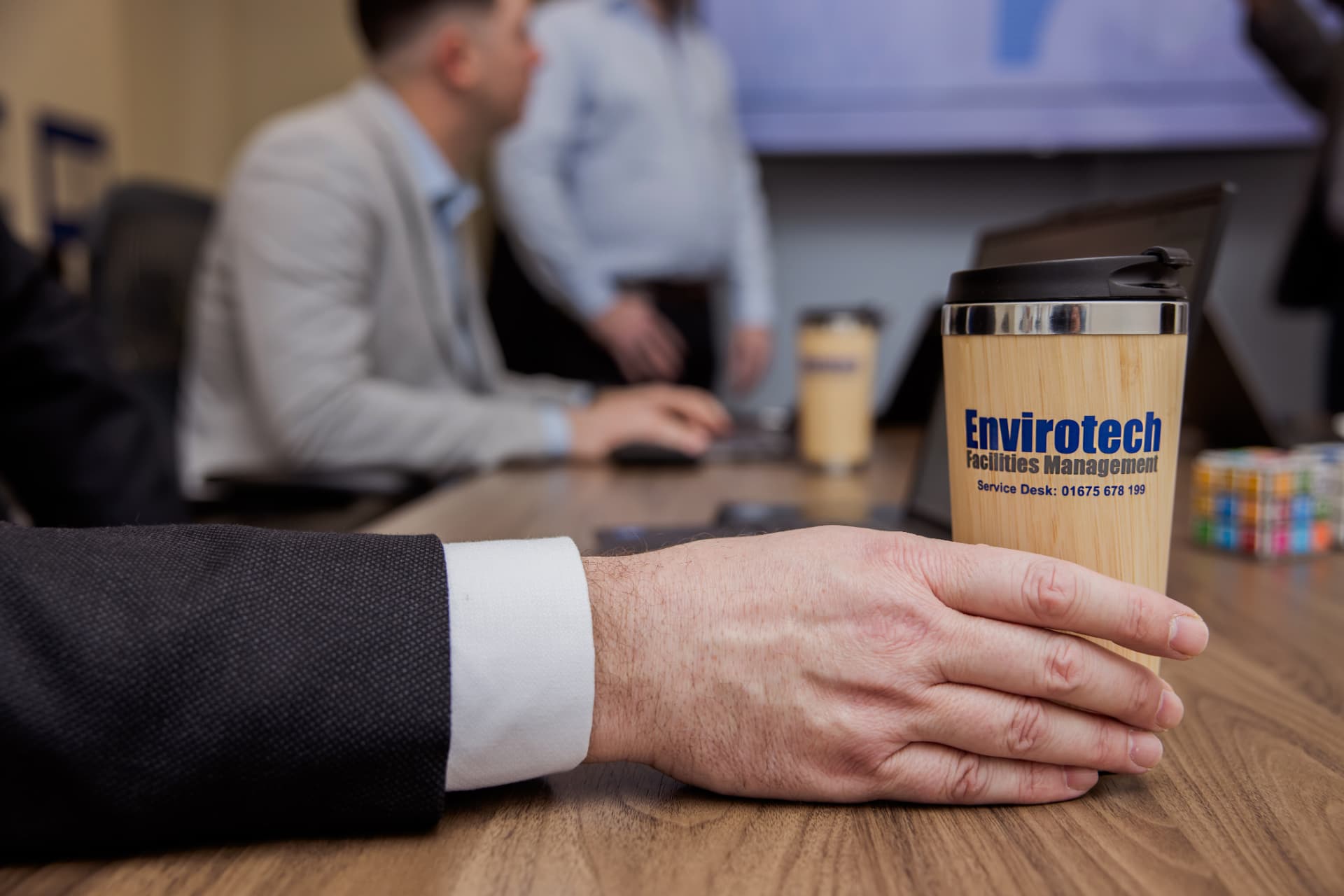 Envirotech FM branded reusable cup on the boardroom table