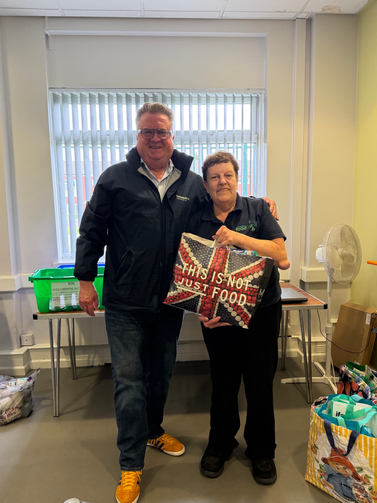 Jeff Smith and Sian Hucker delivering donations inside the food bank
